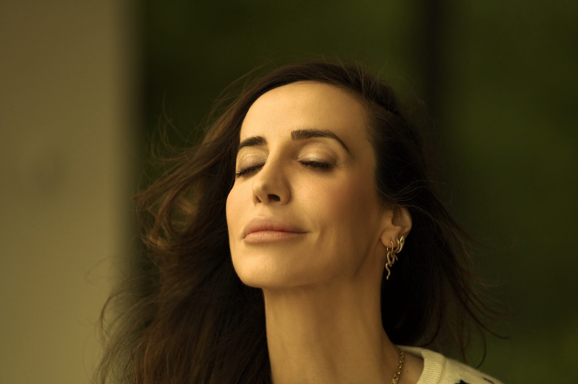 Nilufer Bracco, eyes closed, the silk against her skin