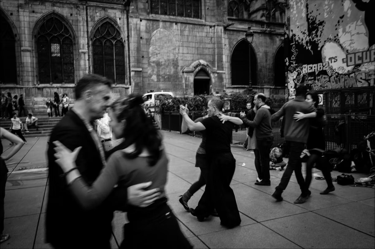 Couples dancing tango in a public square